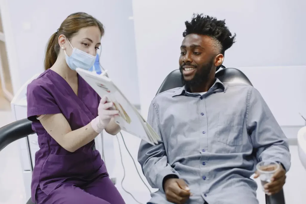Dental professional in a modern clinic consulting with a patient about treatment options