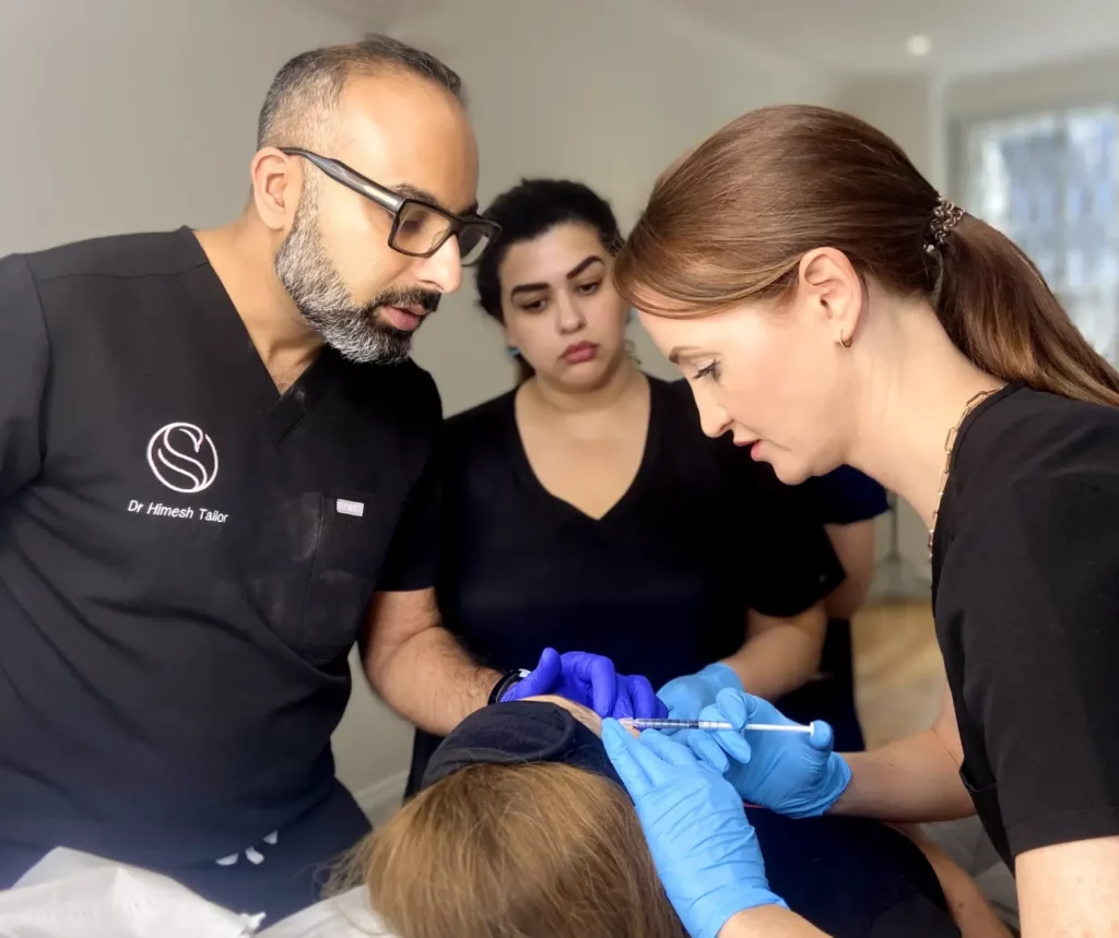 Complete Foundation Aesthetics Course - delegate practicing toxin treatment under supervision of Dr Himesh Tailor